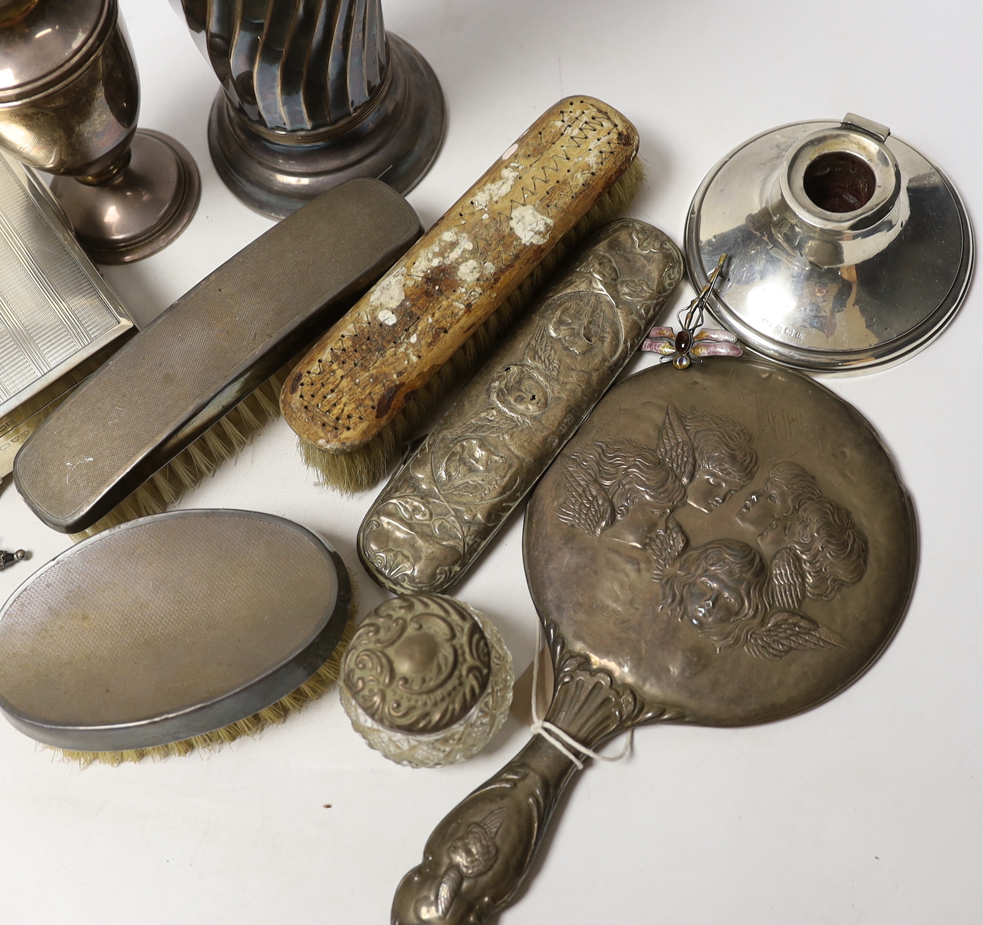 A group of sundry silver including an Edwardian demi-wrythened vase, London, 1901, 24.3cm, mounted hand mirror and three brushes, cigarette box, sugar caster and a damaged inkwell, together with a 1970's silver and ename